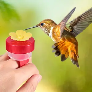 Ring Bird Feeder - 2 Pack Handheld Hummingbird Feeders 7 Hummingbird drinking from a ring bird feeder worn on a finger, close-up view