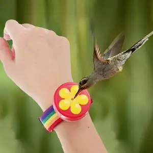 Ring Bird Feeder - 2 Pack Handheld Hummingbird Feeders 6 Hummingbird perched on a ring bird feeder worn on a wrist