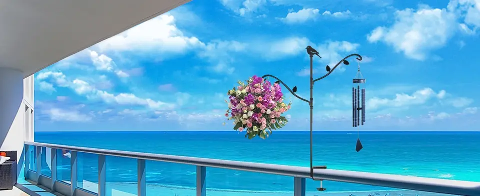 42" Heavy Duty Bird Feeder Pole for Deck | Adjustable & Detachable 7 A peaceful balcony scene with a bird feeding station on the railing, complemented by flowers and the ocean backdrop