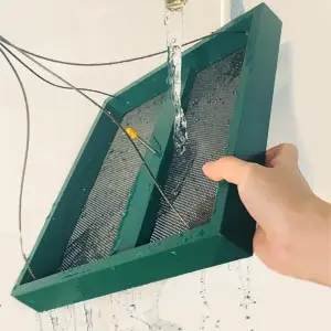 Large Capacity Garden Platform Bird Feeder for Birds & Squirrel 5 easy clean platform bird feeder with mesh bottom being washed under a water tap for easy maintenance